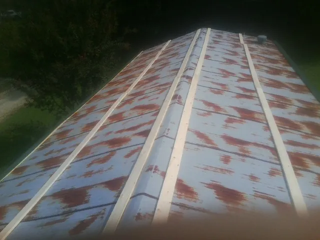 Rusted metal roof panels with new wood purlins before replacement — Storm Damage Roof Repair in Pascagoula by Roofing Brothers